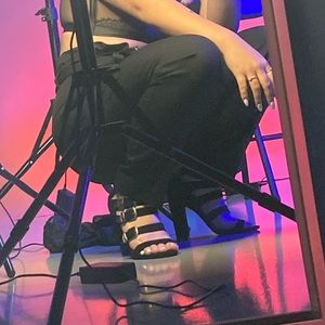 Black heels with silver buckle.